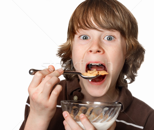 Teen boy eating a bowl of cereal Stock photo © soupstock