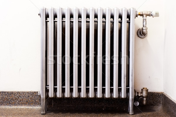 Closeup of an old radiator with a new thermostat Stock photo © soupstock