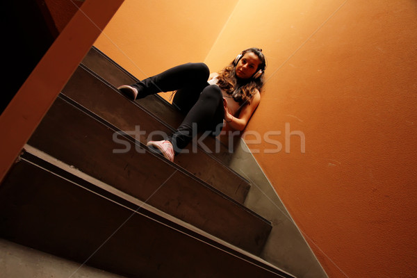 Melancólico escada mulher jovem escuta música sessão Foto stock © Spectral