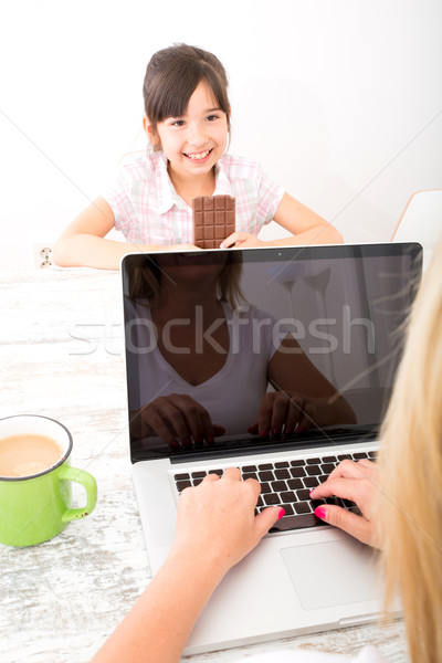 Daughter eating chocolate Stock photo © Spectral