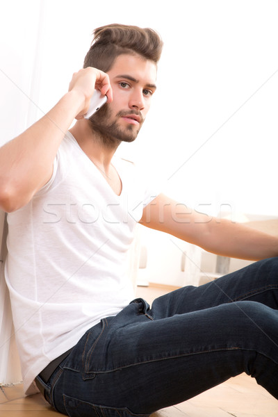 Telefon fiatal felnőtt férfi ül otthon beszél Stock fotó © Spectral