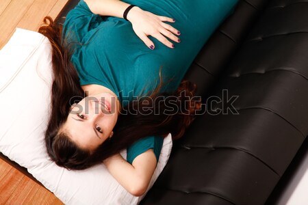 Young woman relaxing on sofa			 Stock photo © Spectral