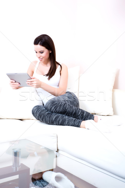 Young woman using a Tablet PC on the Sofa	 Stock photo © Spectral