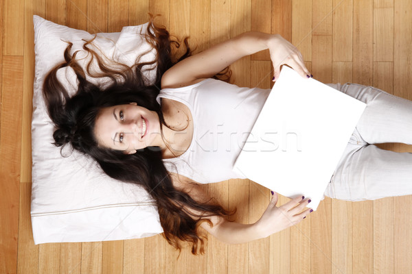 Stock photo: Young woman with a blank Canvas