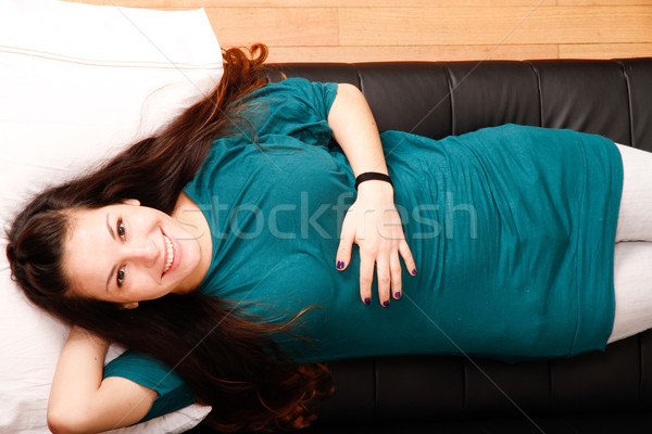 Young woman relaxing on sofa			 Stock photo © Spectral
