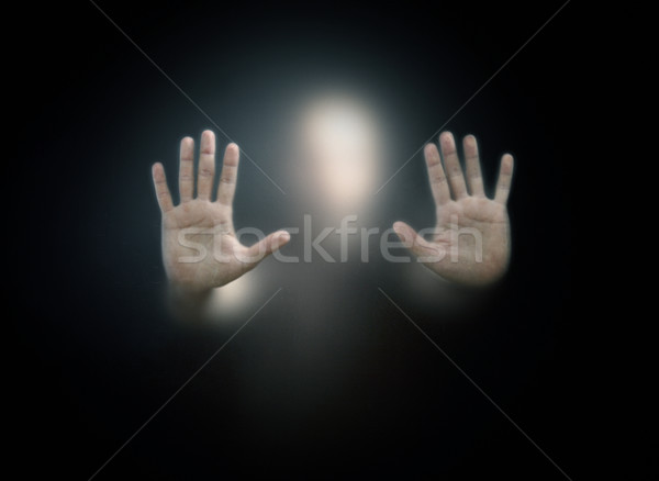 Stock photo: Shadowy figure behind a dusty scratched glass 