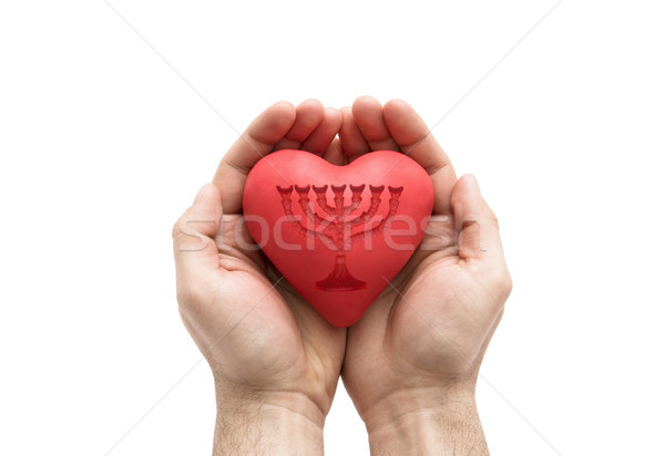 Red heart with imprinted menorah in man's hands.  Stock photo © sqback