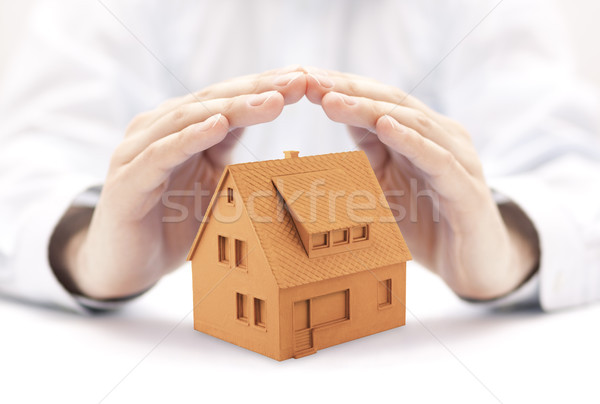 Kicsi narancs ház védett kezek épület Stock fotó © sqback