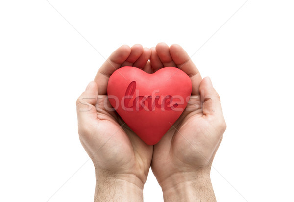 Red heart with imprinted love word in man's hands.  Stock photo © sqback