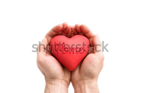 Stock photo: Red heart with imprinted home word in man's hands. 