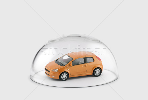Stock photo: Orange car protected under a glass dome 