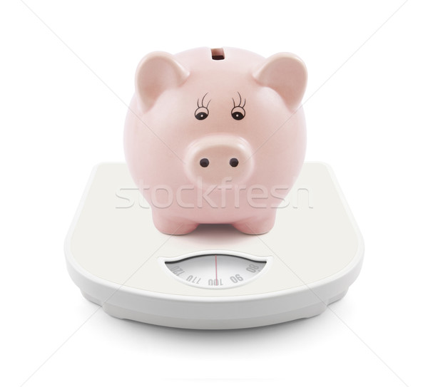 Piggy bank on scales Stock photo © sqback