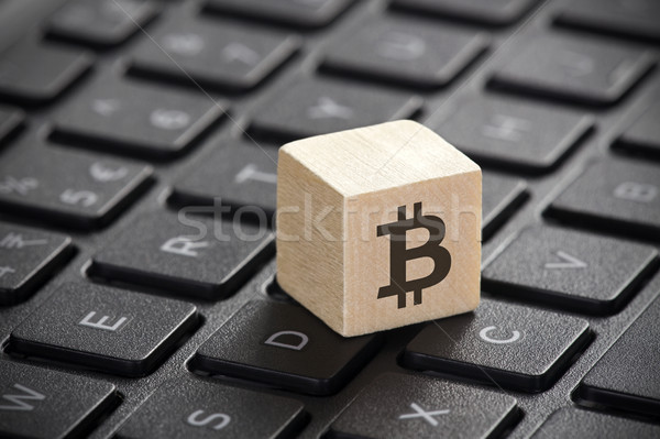Wooden block with bitcoin graphic on laptop keyboard  Stock photo © sqback
