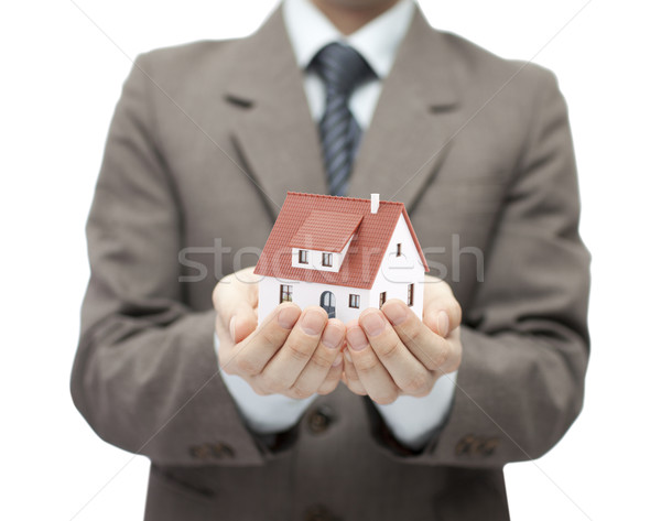 Businessman holding a toy house Stock photo © sqback