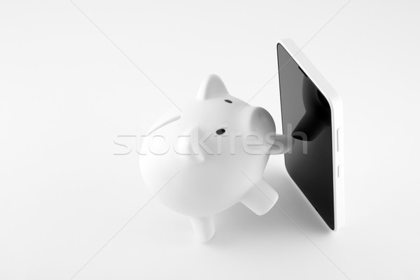 White piggy bank with mobile phone Stock photo © sqback