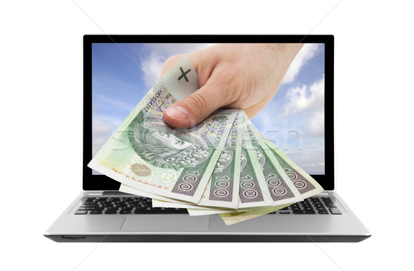 Laptop and hand with polish money. Clipping path included. Stock photo © sqback