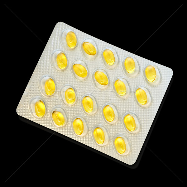 Olio di pesce pacchetto pillole nero medicina giallo Foto d'archivio © SRNR