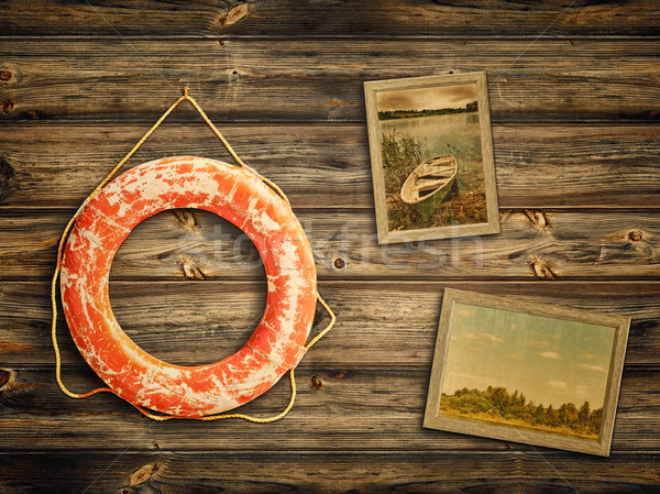 lifebuoy and old travel photos at wooden background Stock photo © SRNR