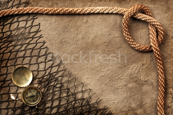 Rough paper with compass, rope, and netting Stock photo © SSilver