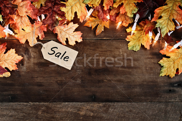 Stock photo: Fall Leaves and Sales Tag over Wooden Background