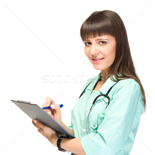 Stock photo: Young woman medical doctor with notebook