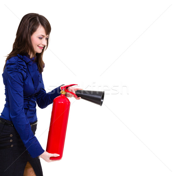 Stock photo: young businesswoman using a fire extinguisher
