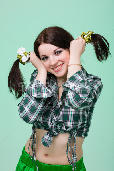 funny cute smiling woman with pigtails  on green Stock photo © stepstock
