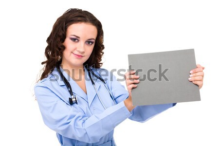 Smiling medical doctor holding blank clipboard Stock photo © stepstock