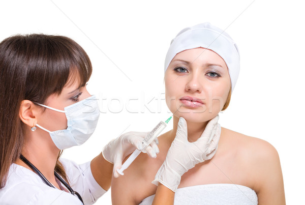 Cosmetic injection to the pretty female face. Stock photo © stepstock