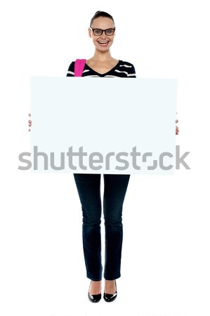 College girl holding white ad board, full length shot Stock photo © stockyimages