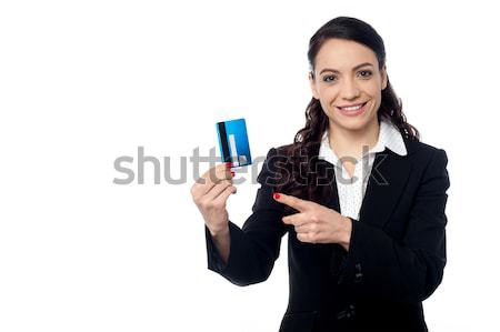 Smiling woman holding up credit card Stock photo © stockyimages