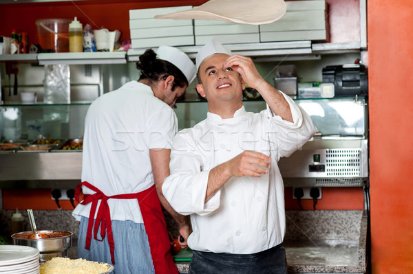 Chef throwing the pizza base dough Stock photo © stockyimages