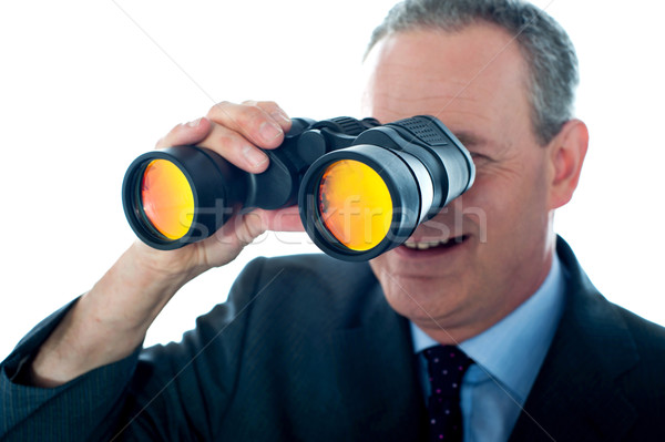 Senior man observing through binoculars Stock photo © stockyimages