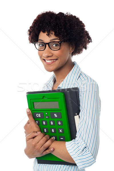Young businesswoman with calculator and file Stock photo © stockyimages
