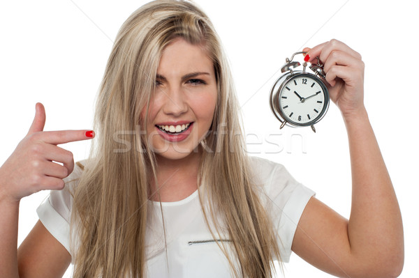 Girl pointing towards old fashioned time piece Stock photo © stockyimages