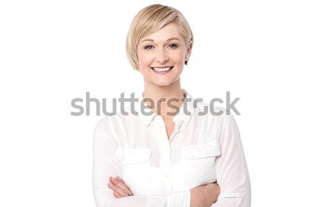 Smiling attractive old lady posing with arms crossed Stock photo © stockyimages