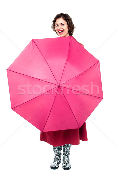 Cheerful woman being playful with umbrella Stock photo © stockyimages