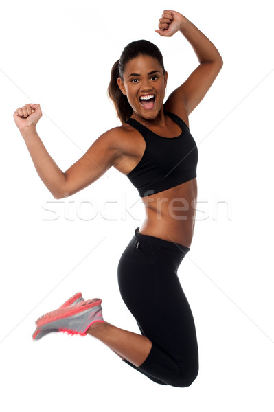 Kobieta odzież sportowa skoki radości piękna kobieta Zdjęcia stock © stockyimages