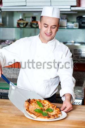 Chef with prepared pizza dough Stock photo © stockyimages