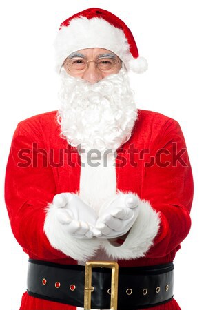 Bespectacled Father Santa posing with open palms Stock photo © stockyimages