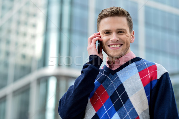 Casual male executive talking via mobile phone Stock photo © stockyimages