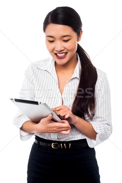 Corporate woman brwosing on tablet pc Stock photo © stockyimages