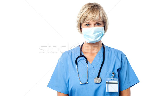 Hölgy orvos visel műtősmaszk női orvos Stock fotó © stockyimages