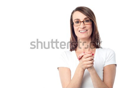 Attractive woman with her hands clasped Stock photo © stockyimages