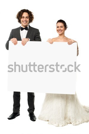 Young couple standing with white board Stock photo © stockyimages