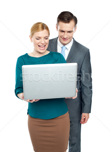 Business people enjoying funny videos on laptop Stock photo © stockyimages