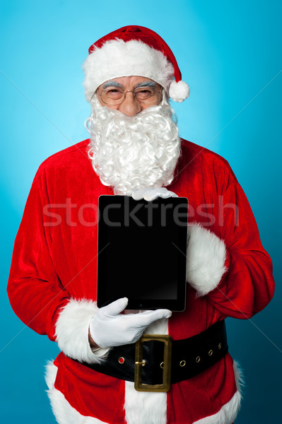 Father Christmas presenting a new tablet device Stock photo © stockyimages