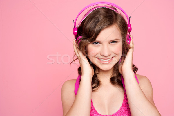 Pretty caucasian girl tuned into music Stock photo © stockyimages
