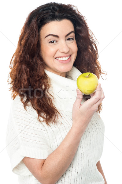Joyous woman with an apple in hand Stock photo © stockyimages