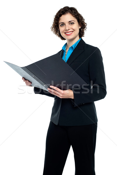 Businesswoman reviewing company documents Stock photo © stockyimages